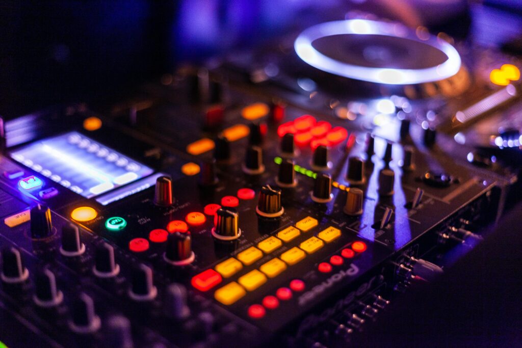 Vibrant DJ mixer with illuminated controls, perfect for music and technology themes.